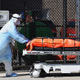 Medical staff move bodies from the Wyckoff Heights Medical Center to a refrigerated truck on April 2, 2020 in Brooklyn, New York.